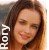 Pixelated portrait of a person with long brown hair, closed eyes, and a slight smile; white text 'ROX' vertically aligned on the left side.