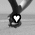 Black-and-white image of two figures holding hands with a heart symbol over their clasped hands, transitioning to one figure standing alone.