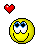 Yellow pixelated smiley face with blue eyes and red hearts arranged in a on gray background