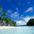 Pixelated beach scene with blue sky, white clouds, green trees, and light blue water on left; cyan text on blue background reads "I belong at the beach" and "Rachel B." on right.