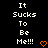 Black background with white pixelated text reading "It Sucks To Be Me!!!" and an orange heart symbol at the bottom right.