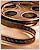 A static pixelated image of a brown and black film reel with visible sprocket holes on the left side, set against a light beige background.