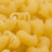 Pixelated image of yellow macaroni pasta on left, blue background with black text 'Pasta Roni' on right.