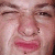 Pixelated close-up of a person's face showing eyes, nose, mouth, and skin texture with visible pixelation and color blending.