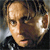 Pixelated close-up of a person's face with light skin tone, dark hair, and a black garment visible at the bottom edge.