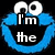 Blue Cookie Monster face with white eyes and mouth, displaying text 'I'm the Cookie Monster' and 'OM NOM NOM!' in white block letters on black background.