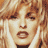 Pixelated close-up of a person's face with light brown hair and dark eyes, rendered in warm tones on a transparent background.