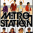 Pixelated image of four figures in a row above large black text reading "METRO STATION" with two smaller figures below, all on light background.
