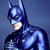 Pixelated image of a figure in a dark blue cowl with pointed ears, wearing a dark blue suit with light blue highlights on the chest and shoulders against a gradient blue background.