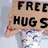 six distinct pixelated icons featuring text, symbols, and imagery including a 'FREE HUGS' sign, peace symbol, hand gesture, globe with figures, and 'LOVE AT WILL' text