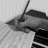 A black-and-white animated sequence showing a hand writing on sheet music with a pen, accompanied by evolving text about writing every note.
