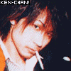 repeated orange cartoon characters with large eyes and open mouths, positioned next to a person in dark clothing holding a cigarette