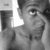 A grayscale pixelated image of a person's face with a bright white light source on the left side, partially obscuring the figure.
