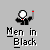 Pixelated figure in black suit with red tie holding red-tipped object, text "Men in Black" below, gray background with light effects.