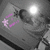 A grayscale image with a bright white circular highlight on the right, featuring scattered pink pixel clusters forming an abstract shape on the left.