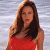 A woman with long brown hair in a red sleeveless top stands against a light blue background, next to green text reading 'Original Icons .com'.