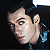 A 50x50 pixel animated buddy icon featuring a side-profile of a person with dark hair and blue eyes on the left, transitioning to green text reading "Original Icons .com" on a solid green background on the right.