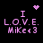 Pixelated pink text and symbols on black background: 'I LOVE. MiKe<3' with heart or starburst above each 'I'.