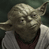 Static pixelated image of a small green alien character with large ears and wrinkled skin wearing a brown robe over white clothing against a dark background.