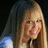 A pixelated image of a person with long light brown hair on the left, next to a bright pink background with red text reading 'hannah montana rox!' on the right.