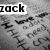 Pixelated grayscale image with partial text 'zack' in bold black letters on a white bar at top left, scattered dark pixel clusters resembling abstract shapes or debris against gray background.