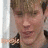 A pixelated image shows a person with light brown hair and closed eyes on the left, next to a dark blue background with orange text reading 'NERD' in blocky letters.