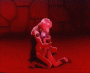 Animated sequence of a character with light hair in red-toned scenes showing kneeling, standing, and facial expressions against stone background.