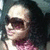 A person with long dark hair and sunglasses wears a pink patterned top, shown in four -aligned views
