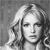 Static grayscale pixel art of a person's face with shoulder-length hair, rendered in low-resolution 256x256 pixels with visible dithering and blocky artifacts.
