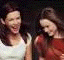 A sequence of animated frames showing two women in white and red tops against a dark background, with changing facial expressions and text overlays.