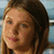 A pixelated image of a woman with brown hair and light eyes, partially visible on the left side of a split-screen layout.