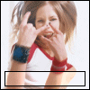 A woman with light brown hair makes a metal sign gesture, wearing red wristbands and blue armbands against a white background.