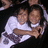 Two people in white shirts embrace against a dark background, with pixelated text on maroon reading 'here we go CENTER' and 'gonna win the parton bowl'