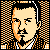 Pixelated 50x50 static buddy icon featuring a stylized human face with orange and black checkered background, rendered in retro video game art style.