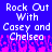 Pixelated text reads "Rock Out With Casey and Chelsea" on a blue background with pink pixelated shapes at the bottom.