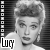 Black-and-white contact sheet of four identical frames showing a woman with styled hair and earrings in a vintage television broadcast style, each frame containing the text "Lucy" at bottom left.