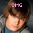 A pixelated image of a person with brown hair wearing a gray jacket over a blue shirt, with pink text above the head.