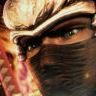 Close-up of a stylized character face with intense expression, featuring dark eye makeup and a mask-like covering over the lower half of the face.