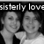 Black-and-white pixelated image of two people in close proximity with partial text above them reading 'sisterly love' on a dark background.