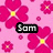 Pixelated pink background with large magenta flowers and yellow centers, featuring a black rectangular text box containing the word 'Sam' in white pixelated letters.