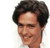 Pixelated close-up of a person with dark curly hair, light skin, and a slight smile against a white background.