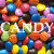 Pixelated image of colorful candy-shaped objects with the word 'CANDY' in white and blue text over a background of multicolored round candies.