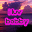 Pixelated image with pink text 'iluv bobby' over a sunset background featuring purple and orange hues.