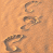 A static image of footprints in sand with overlaid text reading "Im walkin walking in my footsteps again <3".