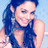 Pixelated image of a person with long dark hair wearing a dark sleeveless top against a light blue background.