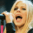 A pixelated image of a blonde woman singing into a microphone with pink text reading HEY HEY and YOU YOU on black backgrounds.
