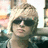 six identical images showing a person with short blonde hair and dark sunglasses, wearing a dark shirt with light stripes, against a blurred background with warm tones