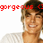 Pixelated image of a person with light brown hair wearing a white shirt, with red text reading 'gorgeous' above the head.