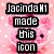 Pixelated pink cartoon character with cherry on head, white @ symbol on chest, black eyes, and white polka dots on pink background.