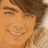 Pixelated image of a smiling person with light brown hair, overlaid with bold black-and-white text reading "no joe no air".